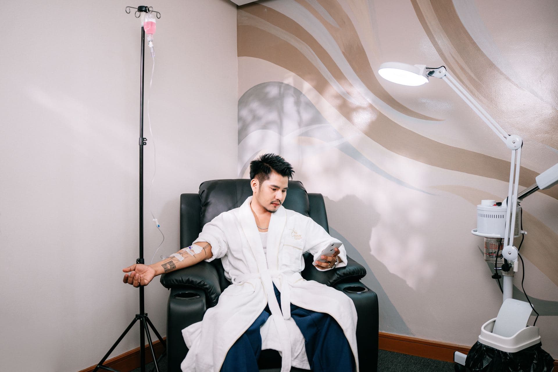 Guest relaxing in a robe in the private wellness lounge